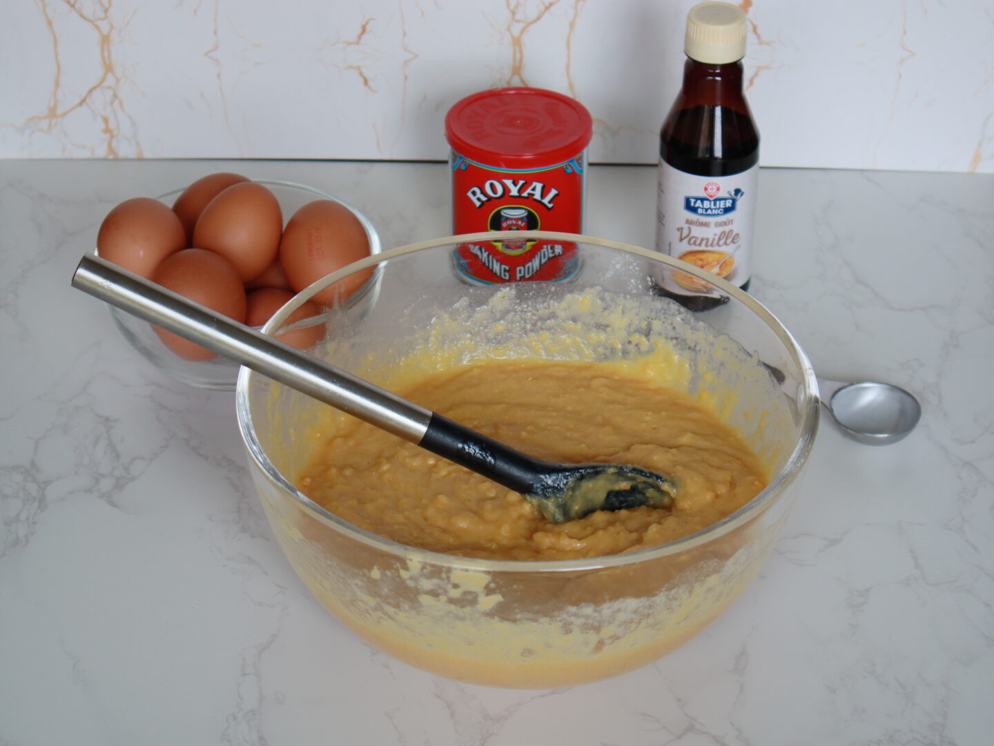 the ingredients for my popular corn cake recipe, vanilla essence, baking powder, eggs and the batter alread prepared to go into the oven